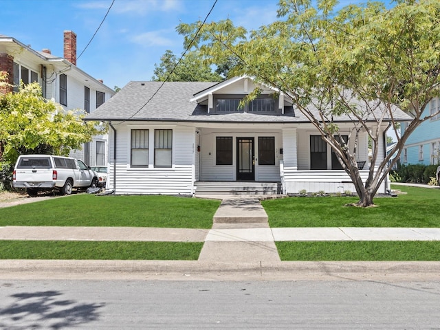 bungalow with a porch and a front yard