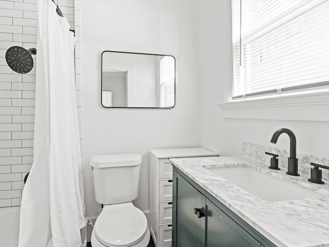 bathroom featuring vanity, toilet, and curtained shower