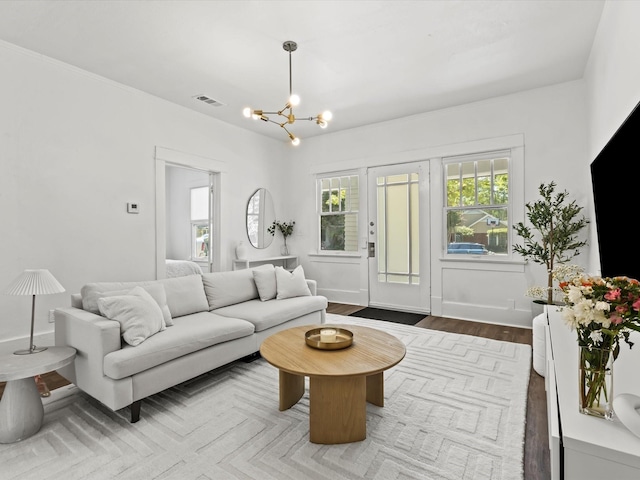 living room with hardwood / wood-style flooring and a chandelier