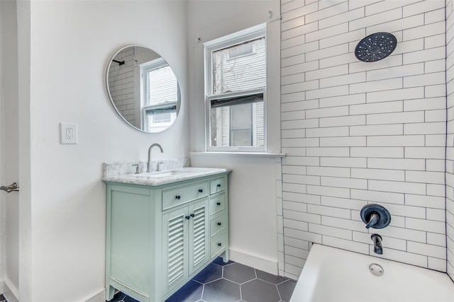 bathroom with tiled shower / bath combo, vanity, and tile patterned flooring