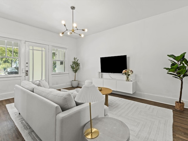 living room with dark wood-type flooring and a chandelier