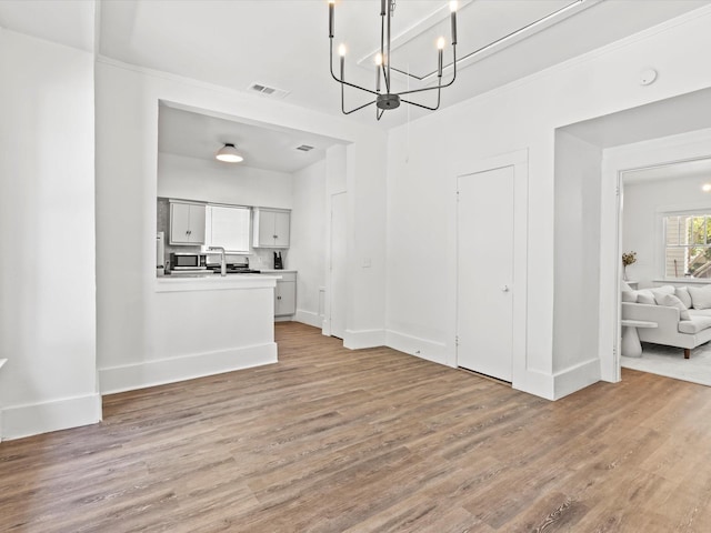 unfurnished dining area with light wood-type flooring and sink