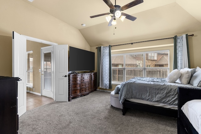 carpeted bedroom with ceiling fan and vaulted ceiling