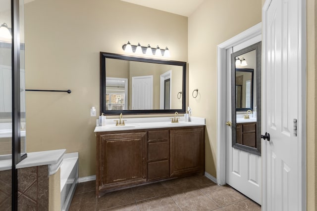 bathroom featuring vanity, tile patterned floors, and a bathing tub