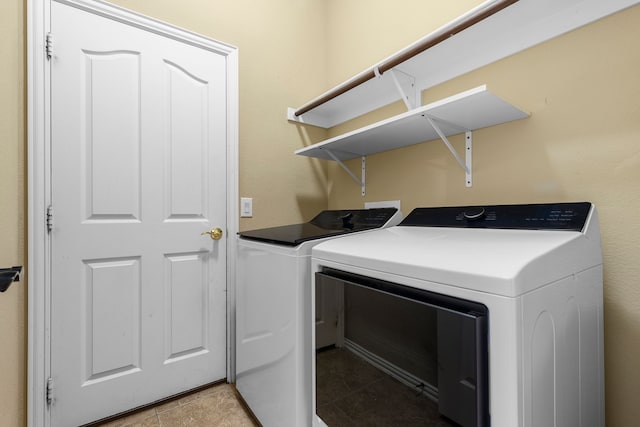 clothes washing area with washing machine and dryer