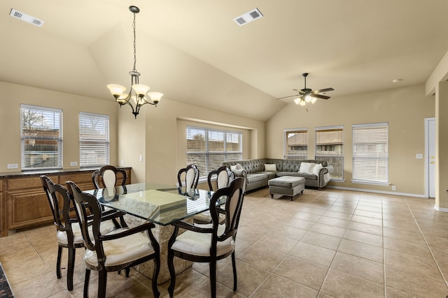 tiled dining area featuring vaulted ceiling, ceiling fan with notable chandelier, and a healthy amount of sunlight