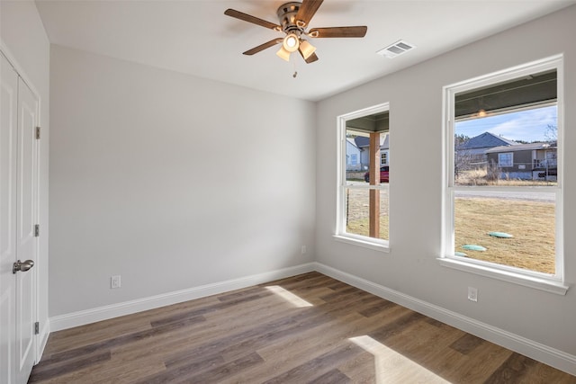 unfurnished room featuring ceiling fan and dark hardwood / wood-style floors