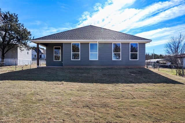 rear view of house with a yard