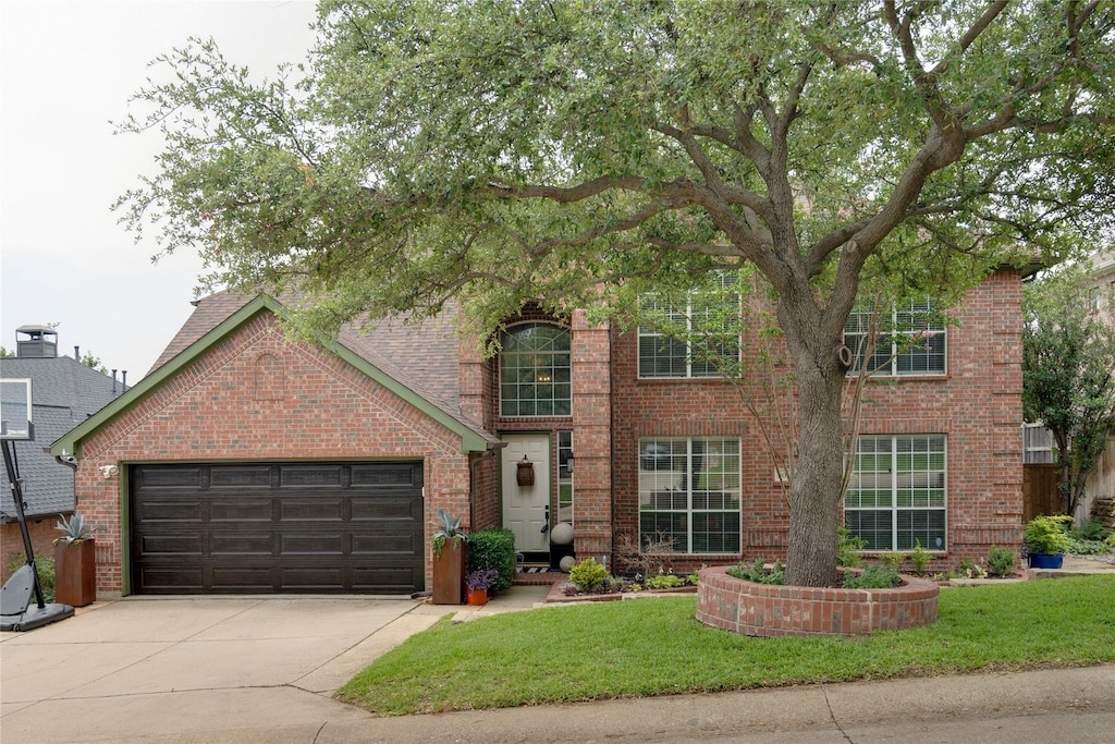 view of front of house featuring a garage and a front lawn