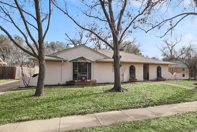 ranch-style house with a front lawn