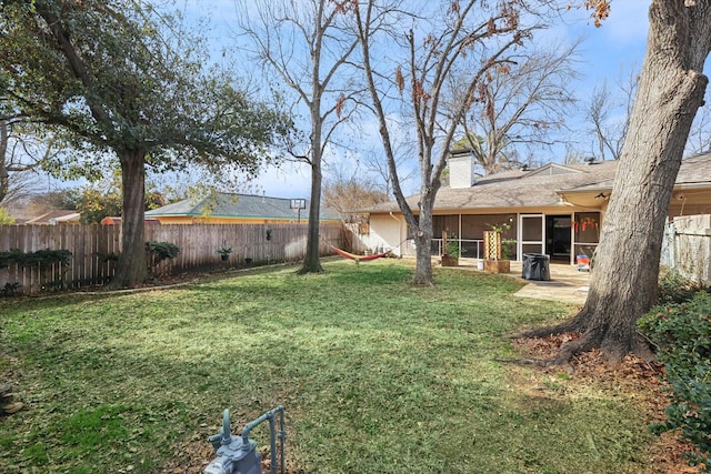 view of yard with a sunroom and a patio area