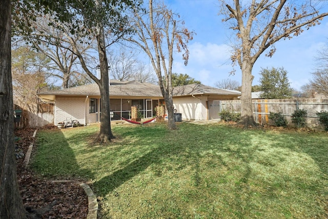 rear view of house featuring a yard