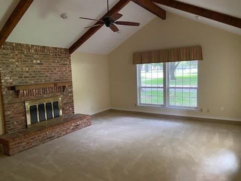 unfurnished living room featuring ceiling fan, carpet flooring, a fireplace, and lofted ceiling with beams