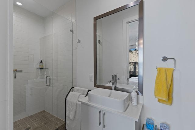 bathroom with vanity and a shower with shower door