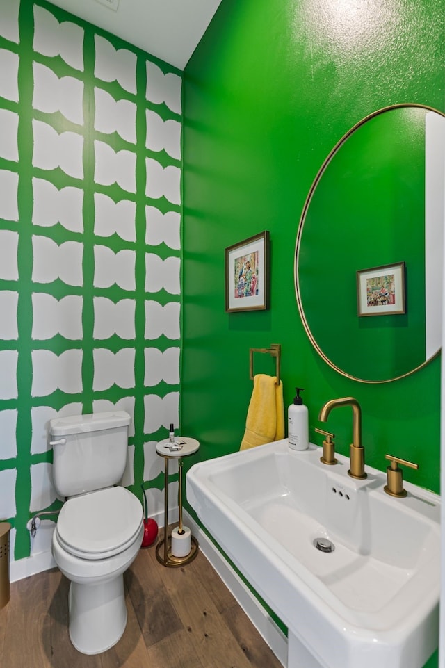 bathroom featuring sink, hardwood / wood-style floors, and toilet