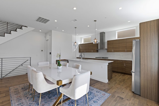 dining area featuring sink and dark wood-type flooring