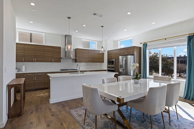 dining area featuring sink and dark hardwood / wood-style flooring