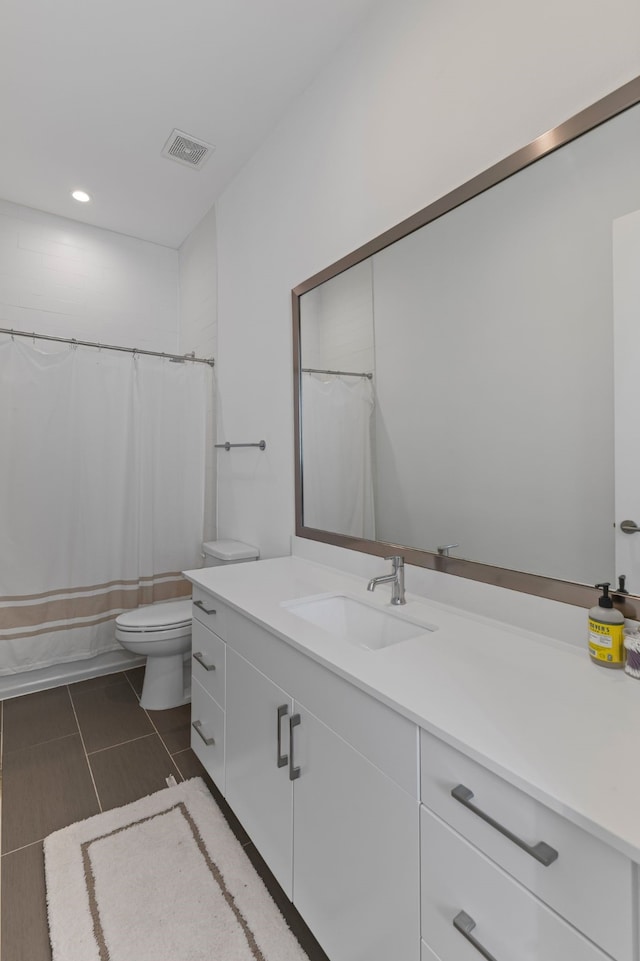 bathroom with vanity, tile patterned flooring, toilet, and a shower with shower curtain