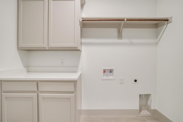 laundry room featuring washer hookup, electric dryer hookup, and cabinets