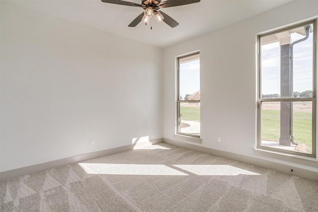 spare room featuring ceiling fan and light carpet