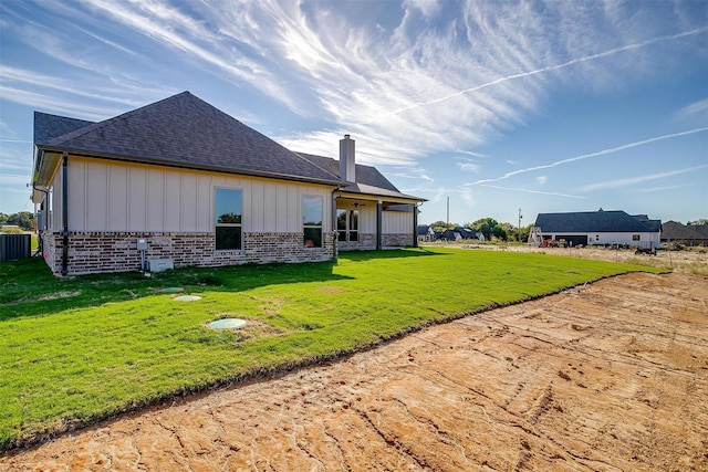 rear view of property with a lawn