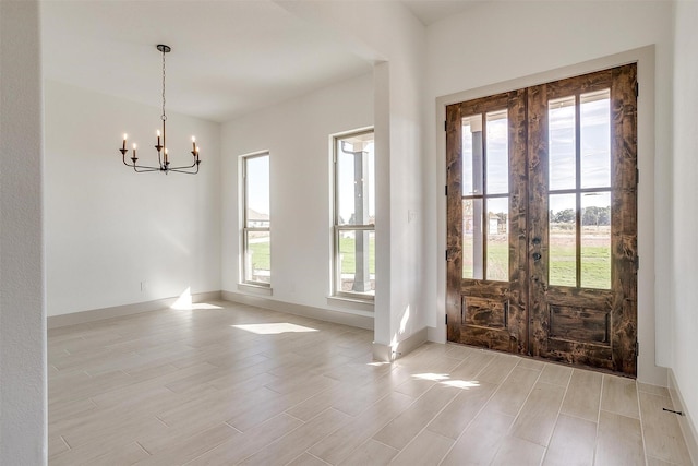 foyer featuring a notable chandelier and french doors