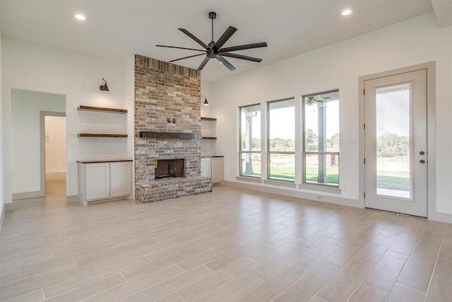 unfurnished living room featuring ceiling fan and light hardwood / wood-style floors