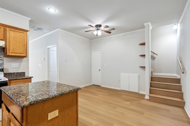 kitchen with ceiling fan, ornamental molding, and light hardwood / wood-style floors