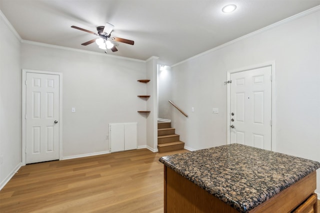 entrance foyer with crown molding, light hardwood / wood-style flooring, and ceiling fan