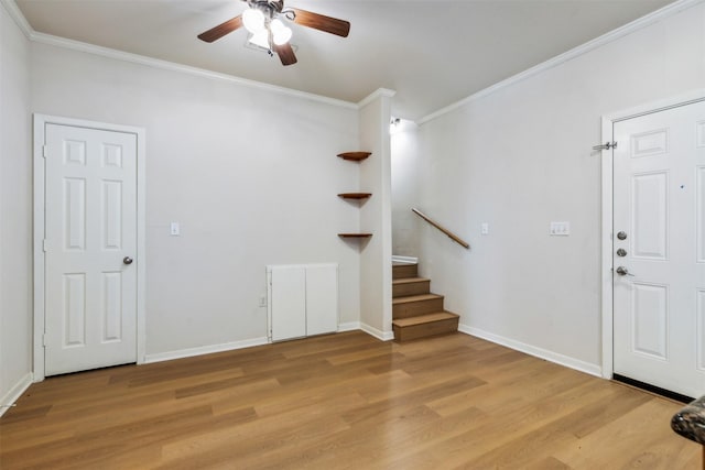 foyer with ceiling fan, ornamental molding, and light hardwood / wood-style flooring