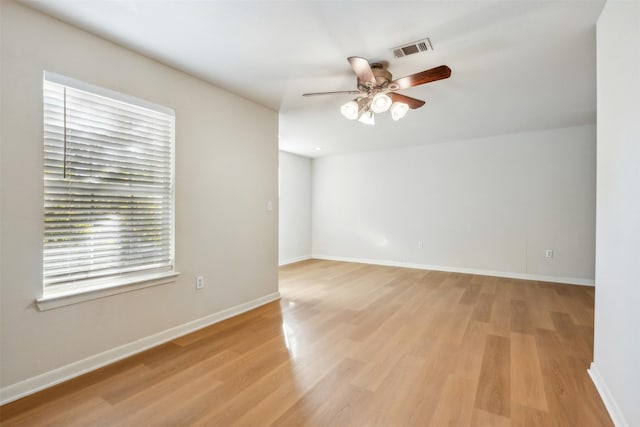 empty room with ceiling fan and light wood-type flooring