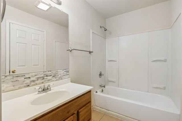 bathroom featuring vanity, tile patterned floors, washtub / shower combination, and decorative backsplash