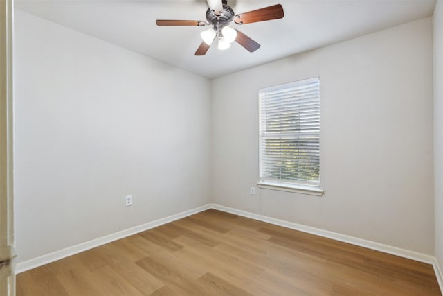 empty room with ceiling fan, plenty of natural light, and light wood-type flooring