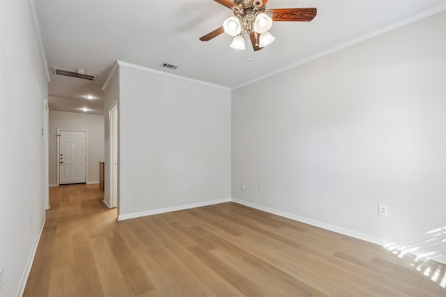 spare room featuring ceiling fan, ornamental molding, and light hardwood / wood-style floors