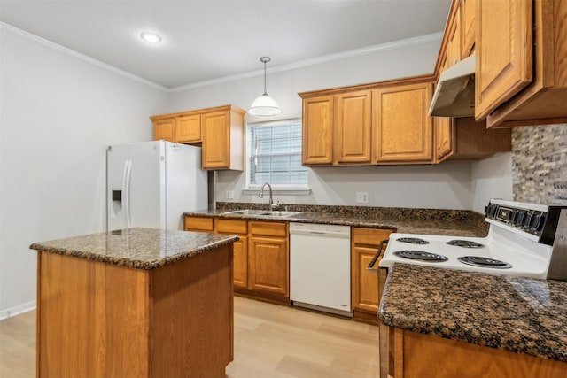 kitchen with decorative light fixtures, sink, ornamental molding, a center island, and white appliances