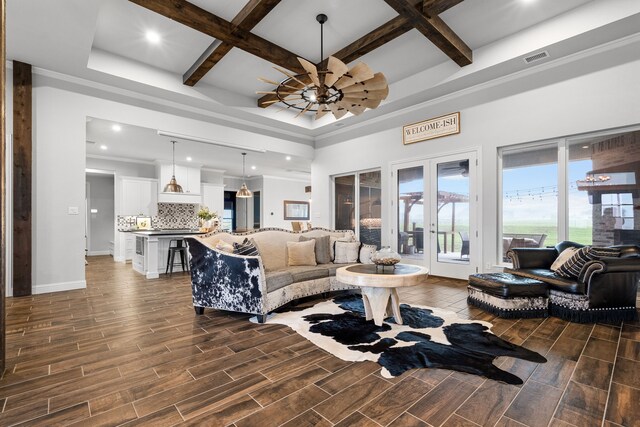 living room with coffered ceiling, french doors, ceiling fan, and beam ceiling