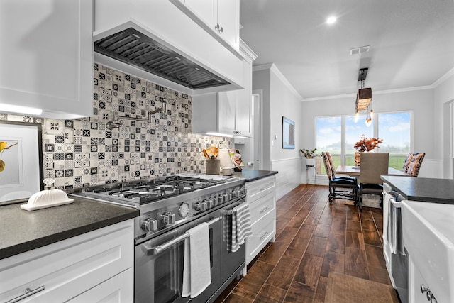 kitchen with pendant lighting, white cabinets, crown molding, double oven range, and custom range hood