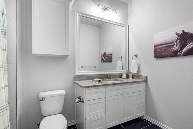 bathroom with vanity, toilet, and tile patterned flooring