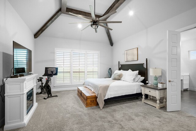 bedroom featuring carpet, lofted ceiling with beams, and ceiling fan