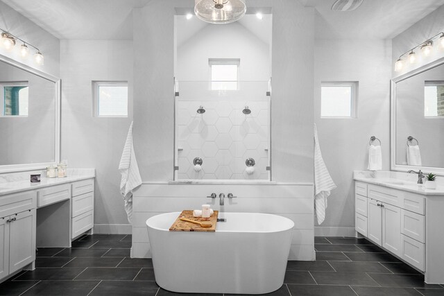 bathroom featuring a healthy amount of sunlight, independent shower and bath, tile patterned floors, and vanity