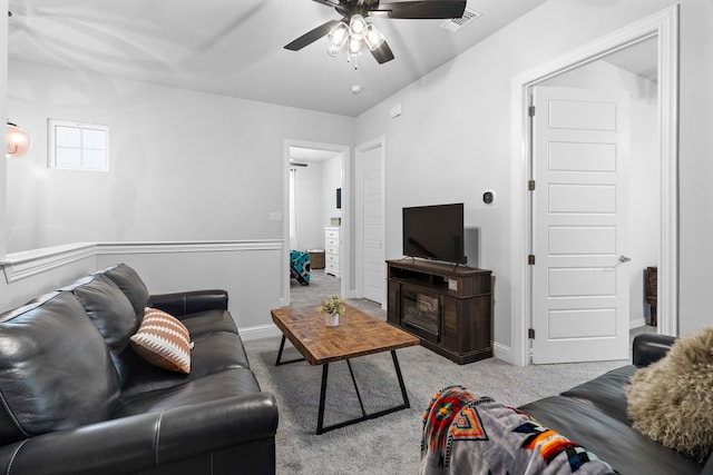 living room featuring ceiling fan and light colored carpet