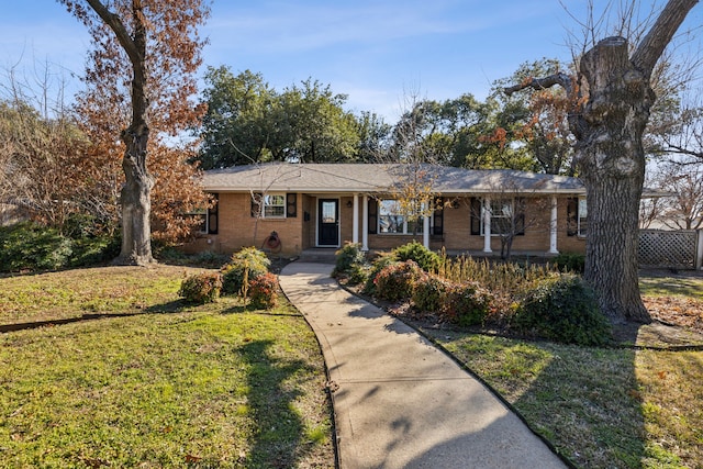 ranch-style home featuring a front yard