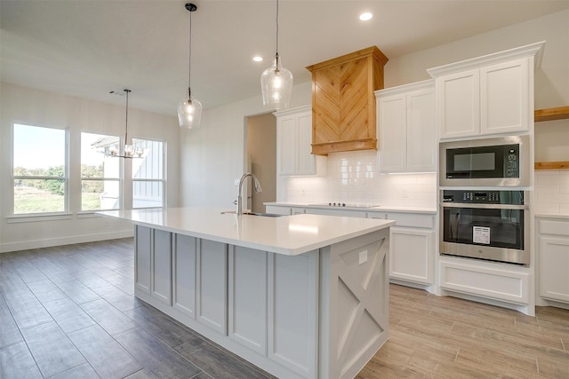 kitchen with sink, black appliances, and white cabinetry