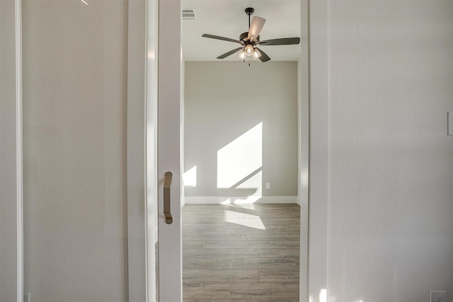 corridor with hardwood / wood-style flooring