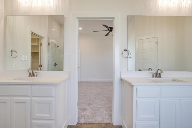 bathroom featuring ceiling fan, a shower with door, and vanity