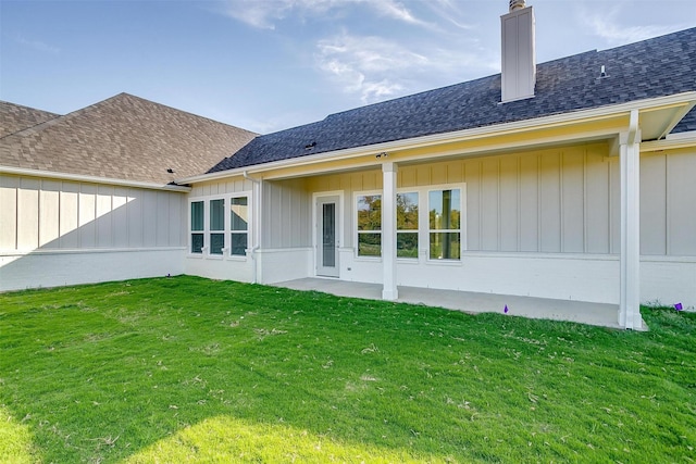 rear view of house featuring a yard