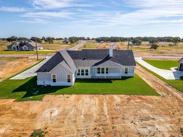 back of property featuring a lawn