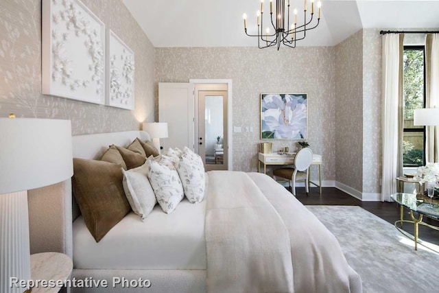 bedroom featuring an inviting chandelier and dark hardwood / wood-style flooring