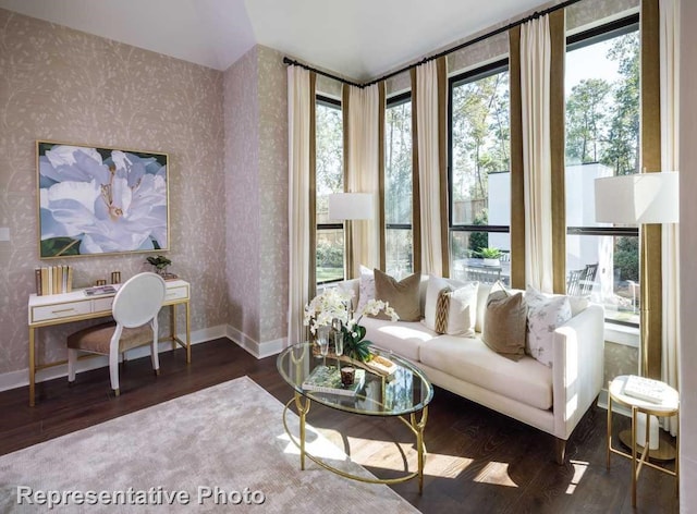 living room with plenty of natural light and dark hardwood / wood-style flooring