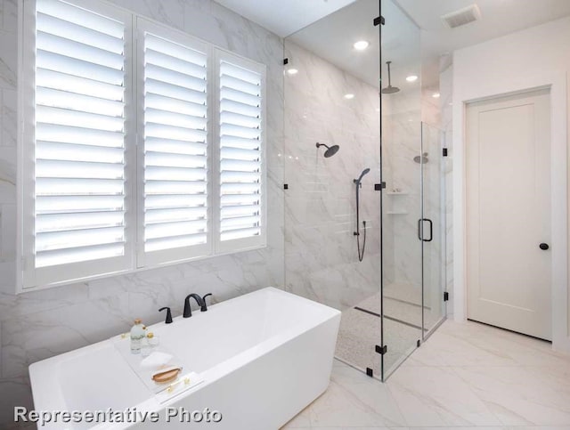 bathroom featuring independent shower and bath and tile walls